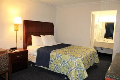 a hotel room with a bed and a window at Americas Best Value Inn of Decatur in Decatur