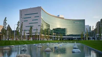 a large building with a pond in front of it at InterContinental Cleveland by IHG in Cleveland