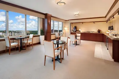 a restaurant with tables and chairs and large windows at InterContinental Cleveland by IHG in Cleveland