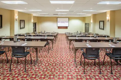 a classroom with tables and chairs in a room at Crowne Plaza Cleveland Airport by IHG in Middleburg Heights
