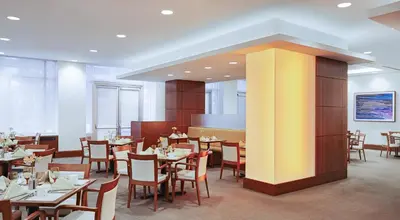 a restaurant with tables and chairs in a room at InterContinental Suites Hotel Cleveland by IHG in Cleveland