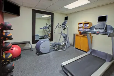 a gym with exercise equipment and a treadmill at Homewood Suites by Hilton Dayton South in Miamisburg