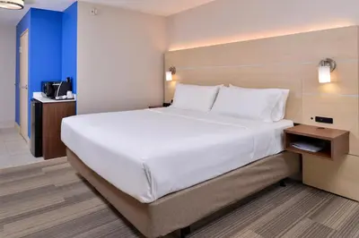 a large white bed in a hotel room at Holiday Inn Express Hotel & Suites Cincinnati - Mason by IHG in Mason