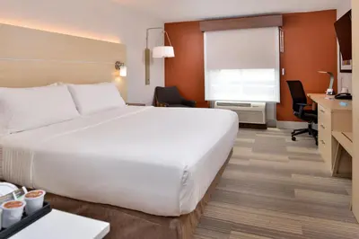 a large white bed in a hotel room at Holiday Inn Express Hotel & Suites Cincinnati - Mason by IHG in Mason