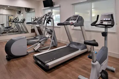 a gym with several exercise bikes in a room at Holiday Inn Express Hotel & Suites Cincinnati - Mason by IHG in Mason