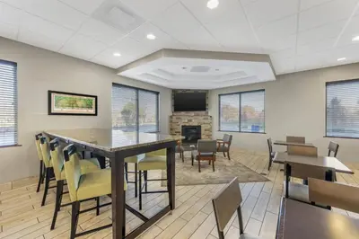 a conference room with a table and chairs and a fireplace at Best Western Columbus Airport in Columbus