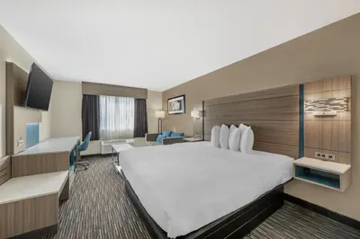 a hotel room with a large bed and a television at Best Western Columbus Airport in Columbus