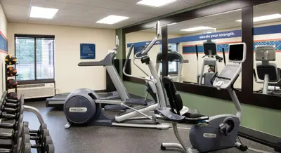 a gym with two tread machines and a mirror at Hampton Inn Cleveland-Solon in Solon