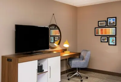 a computer desk with a monitor and a chair at Hampton Inn Cleveland-Solon in Solon