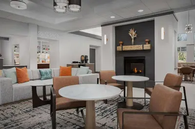 a lobby with couches and tables and a fireplace at Homewood Suites by Hilton Cleveland-Solon in Solon
