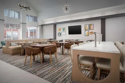 a restaurant with tables and chairs and a flat screen tv at Homewood Suites by Hilton Cleveland-Solon in Solon