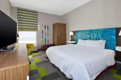 a hotel room with a bed and a flat screen tv at Hampton Inn Marysville in Marysville
