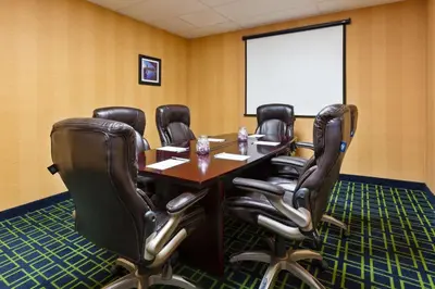 a conference room with a table and leather chairs at Hampton Inn Marysville in Marysville