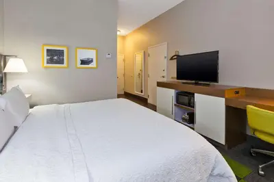 a hotel room with a bed and a flat screen tv at Hampton Inn Marysville in Marysville