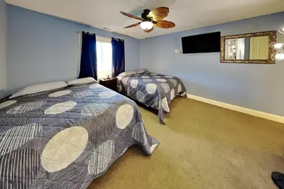 a bedroom with two beds and a ceiling fan at Put-in-Bay Waterfront Condo #205 in Put-in-Bay