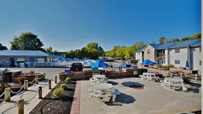 a parking lot with tables and blue umbrellas at Put-in-Bay Waterfront Condo #205 in Put-in-Bay