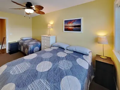 a bedroom with two beds and a ceiling fan at Put-in-Bay Waterfront Condo #211 in Put-in-Bay