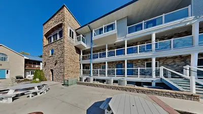 a large brick building with tables in front of it at Put-in-Bay Waterfront Condo #211 in Put-in-Bay