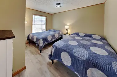 a bedroom with two beds and a window at Put-in-Bay Island Club #111 in Put-in-Bay