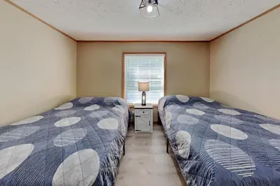 a bedroom with two beds and a window at Put-in-Bay Island Club #111 in Put-in-Bay