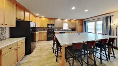 a kitchen with a large island with bar stools at Put-in-Bay Island Club #111 in Put-in-Bay