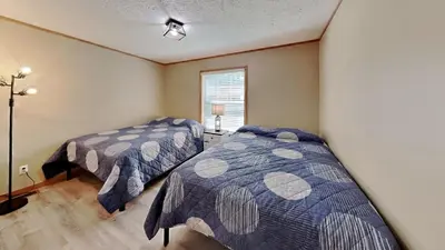 a bedroom with two beds and a window at Put-in-Bay Island Club #111 in Put-in-Bay