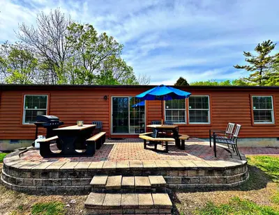 a patio with a picnic table and an umbrella at Put-in-Bay Island Club #77 in Put-in-Bay