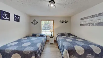 a bedroom with two beds and a window at Put-in-Bay Island Club #77 in Put-in-Bay