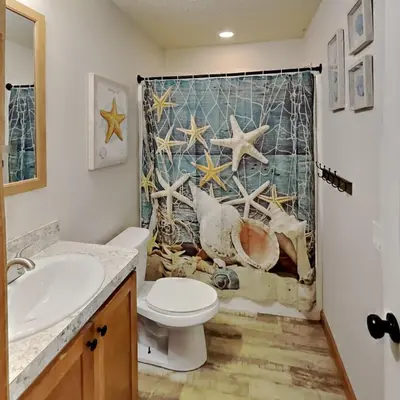 a bathroom with a toilet and a shower curtain at Put-in-Bay Island Club #77 in Put-in-Bay