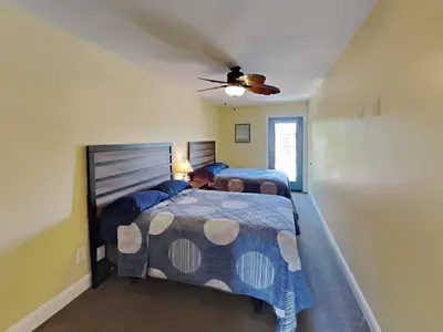 a bedroom with two beds and a ceiling fan at Put-in-Bay Waterfront Condo #202 in Put-in-Bay