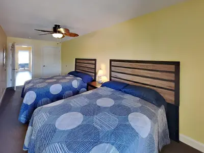 a bedroom with two beds and a ceiling fan at Put-in-Bay Waterfront Condo #202 in Put-in-Bay
