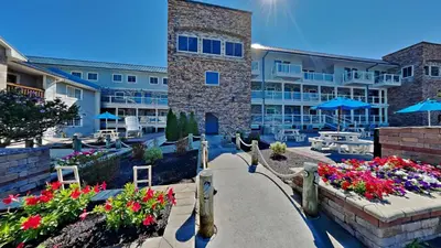 a walkway in front of a resort with flowers at Put-in-Bay Waterfront Condo #202 in Put-in-Bay