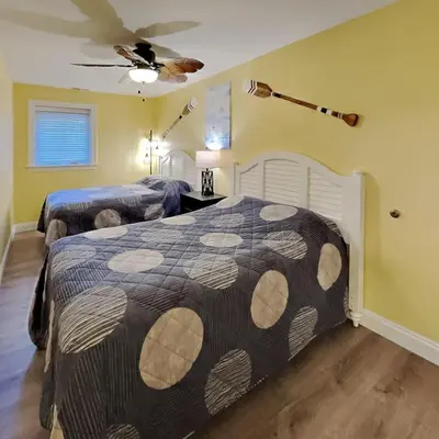 a bedroom with two beds and a ceiling fan at Put-in-Bay Waterfront Condo #104 in Put-in-Bay