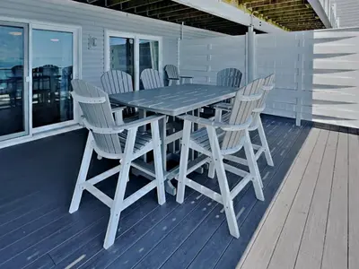 a wooden table and chairs on a deck at Put-in-Bay Waterfront Condo #104 in Put-in-Bay