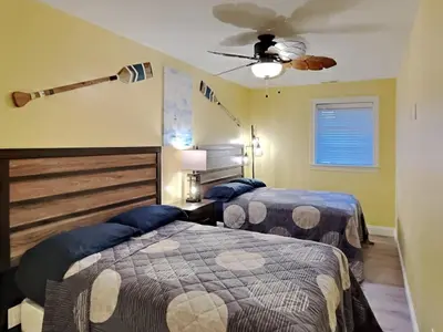a bedroom with two beds and a ceiling fan at Put-in-Bay Waterfront Condo #105 in Put-in-Bay