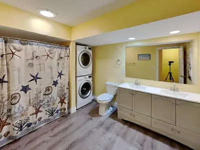 a bathroom with a sink toilet and a washing machine at Put-in-Bay Waterfront Condo #105 in Put-in-Bay