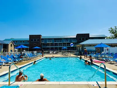 a pool at a hotel with people playing in it at Put-in-Bay Waterfront Condo #105 in Put-in-Bay