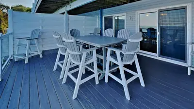 a wooden table and chairs on a deck at Put-in-Bay Waterfront Condo #106 in Put-in-Bay