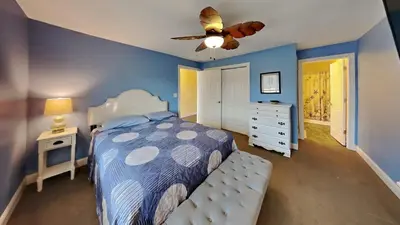 a bedroom with a bed and a ceiling fan at Put-in-Bay Waterfront Condo #106 in Put-in-Bay