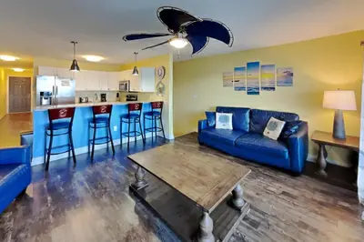 a living room with a couch and a table at Put-in-Bay Waterfront Condo #111 in Put-in-Bay