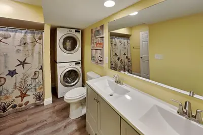 a bathroom with a washing machine and a washer and dryer at Put-in-Bay Waterfront Condo #111 in Put-in-Bay