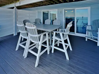 a wooden table and chairs on a deck at Put-in-Bay Waterfront Condo #111 in Put-in-Bay
