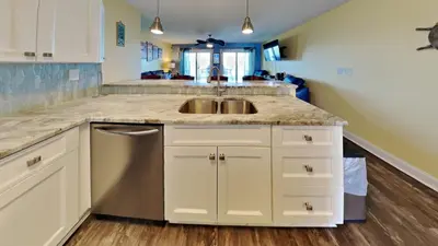 a kitchen with white cabinets and a sink at Put-in-Bay Waterfront Condo #107 in Put-in-Bay