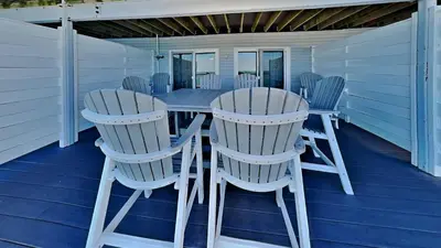 a porch with a table and chairs on it at Put-in-Bay Waterfront Condo #107 in Put-in-Bay