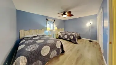a bedroom with two beds and a ceiling fan at Put-in-Bay Waterfront Condo #107 in Put-in-Bay