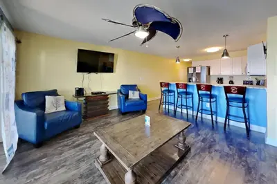 a living room with a couch and a table at Put-in-Bay Waterfront Condo #109 in Put-in-Bay