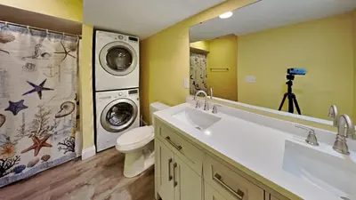 a bathroom with a washing machine and a washer and dryer at Put-in-Bay Waterfront Condo #109 in Put-in-Bay