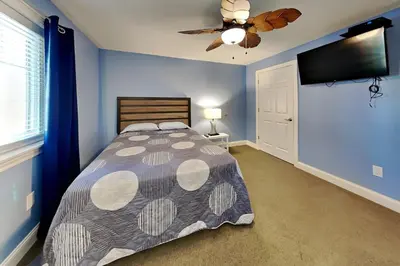 a bedroom with a bed and a ceiling fan at Put-in-Bay Waterfront Condo #109 in Put-in-Bay