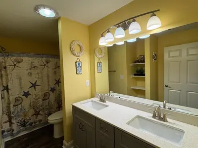 a bathroom with two sinks and a toilet at Put-in-Bay Waterfront Condo #209 in Put-in-Bay