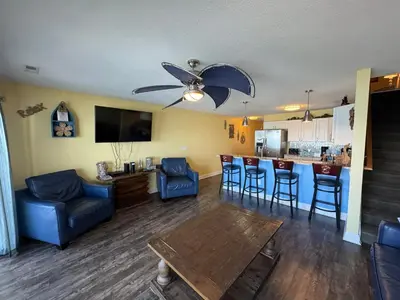 a living room with a couch and a table and a bar at Put-in-Bay Waterfront Condo #209 in Put-in-Bay